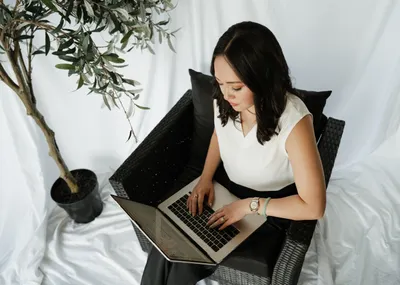 Overhead view of a Lily & Key assistant working on a laptop